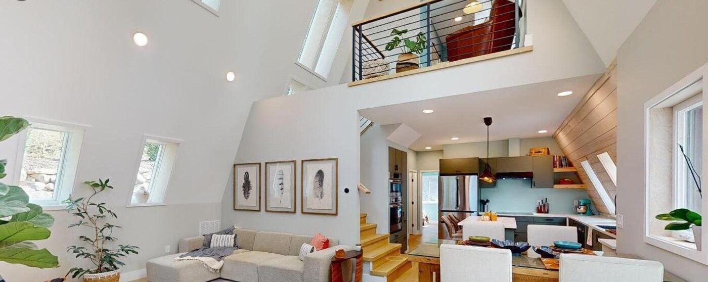 Living area beneath the soaring A-frame ceiling